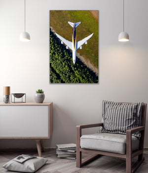 a large airplane flying over a grassy area, with a minimalist and modern interior design in the background.