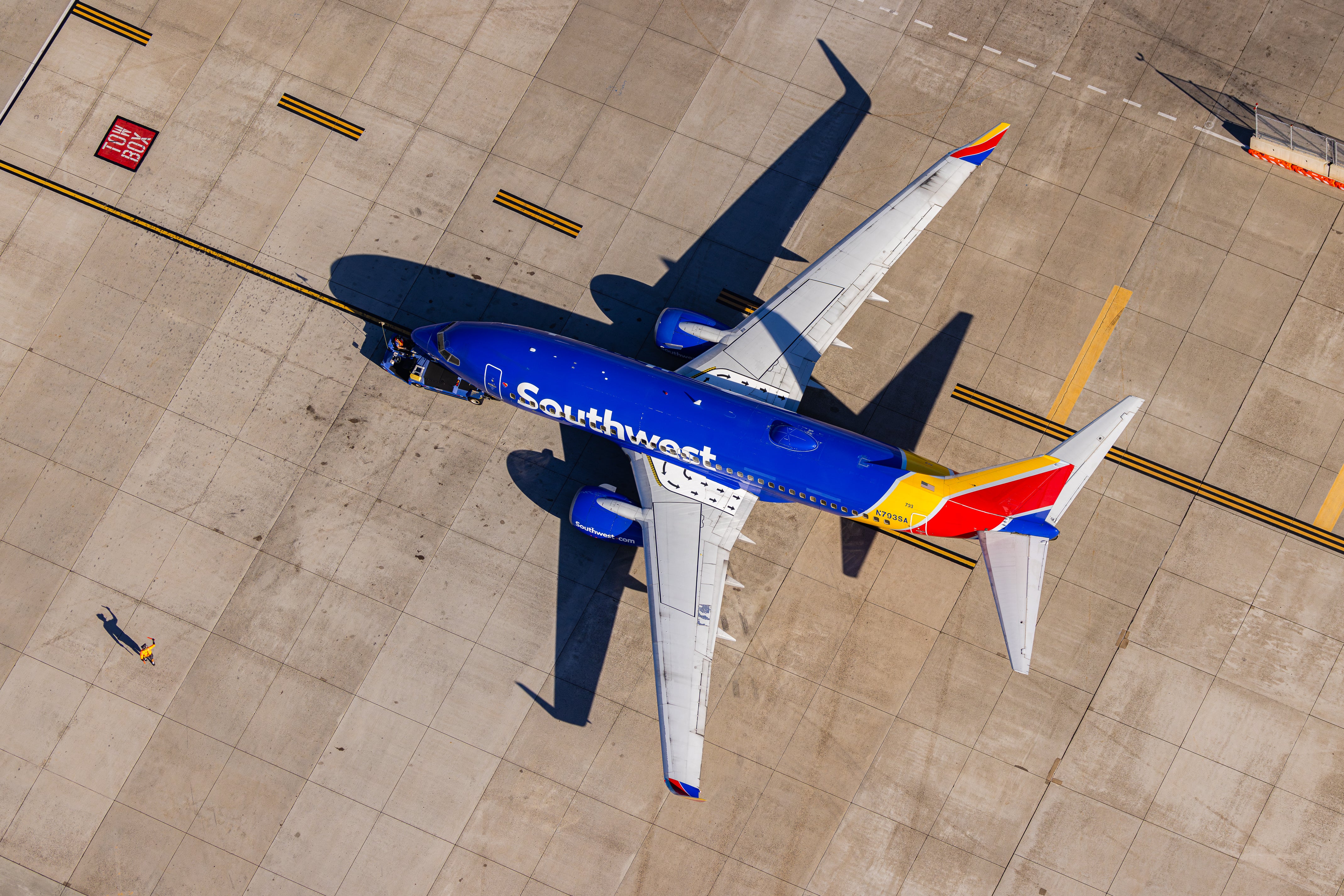 An aerial view of a Southwest Airlines jet parked on the tarmac at an airport.