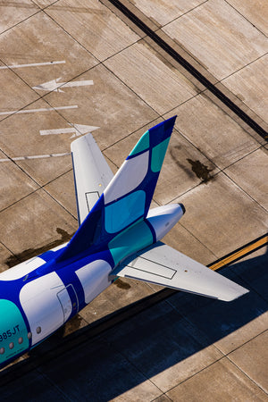 the tail section of a large airplane parked on an airport tarmac.
