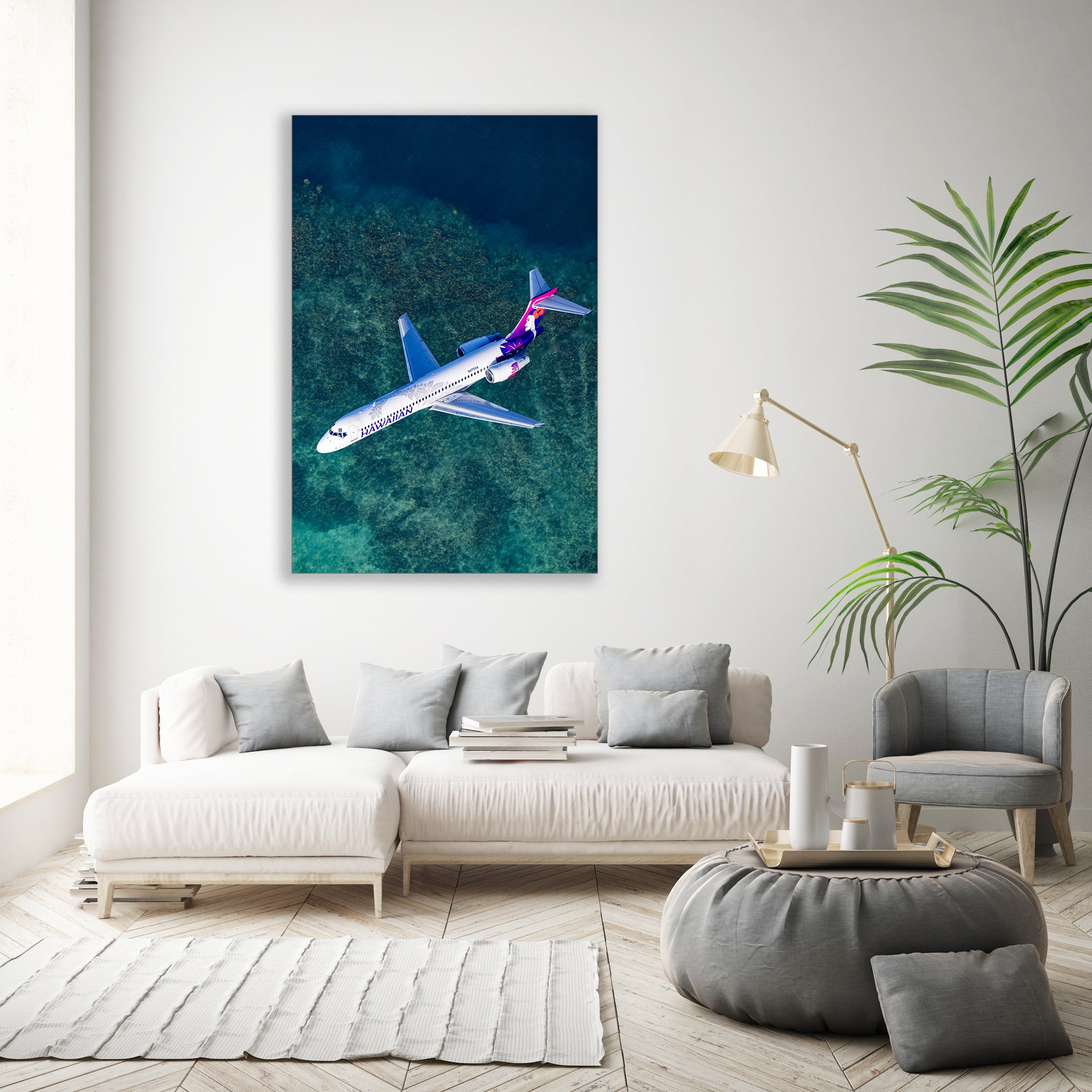 a large airplane flying over a body of water, with a white sofa and a potted plant in the foreground.
