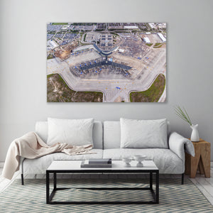 a large aerial view of an airport terminal with multiple buildings and structures surrounding it.