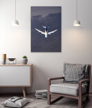 a large airplane flying over a desert landscape, with a minimalist and modern interior design in the background.