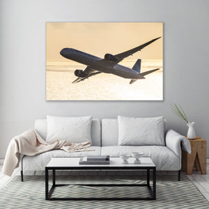 a large airplane flying over a beach at sunset, with the warm colors of the sky and the ocean creating a serene and picturesque scene.