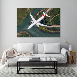 a large airplane flying over a river, with a white couch and a coffee table in the foreground.