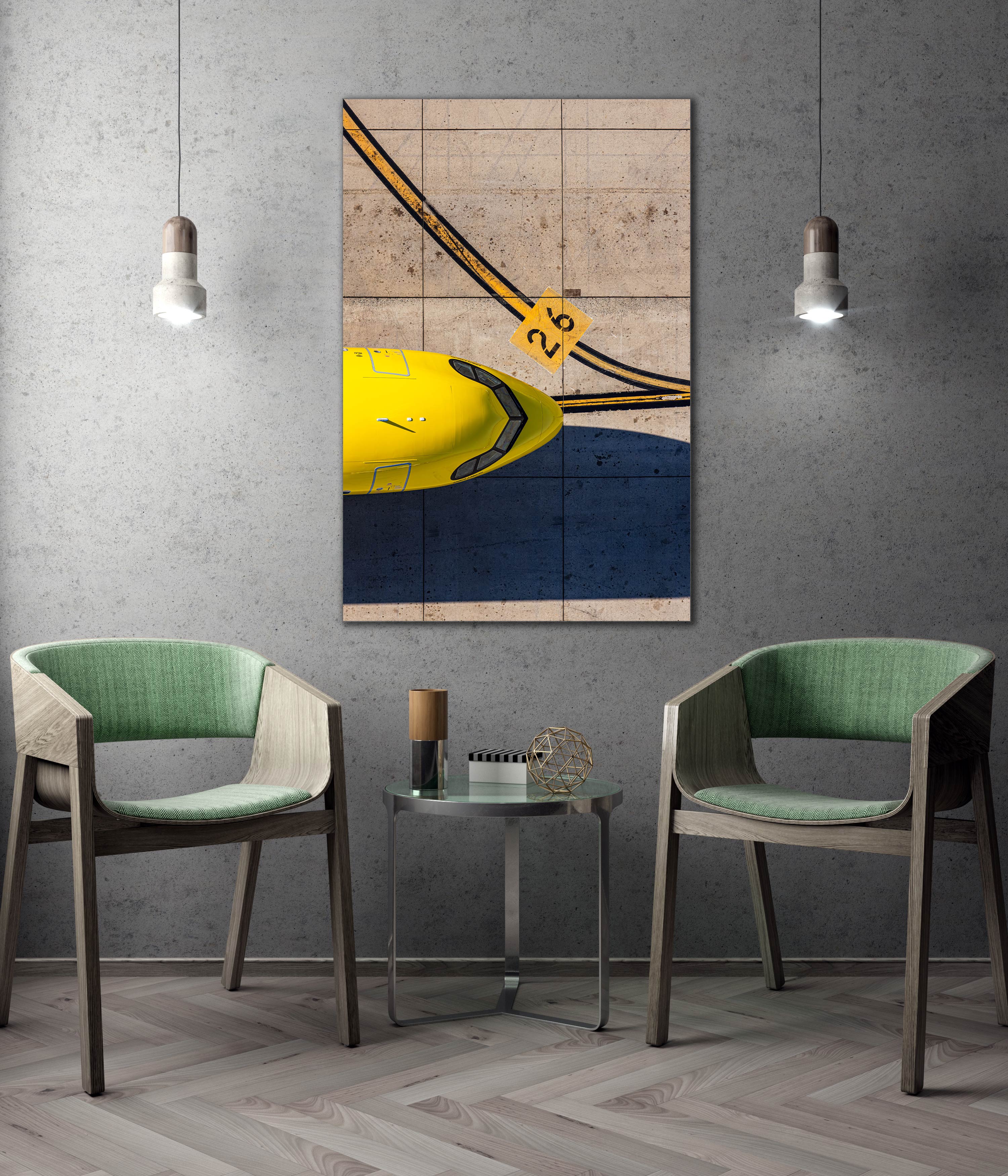 a modern living room with a large abstract painting hanging on the wall, two green chairs, and a small table with a decorative item on it.
