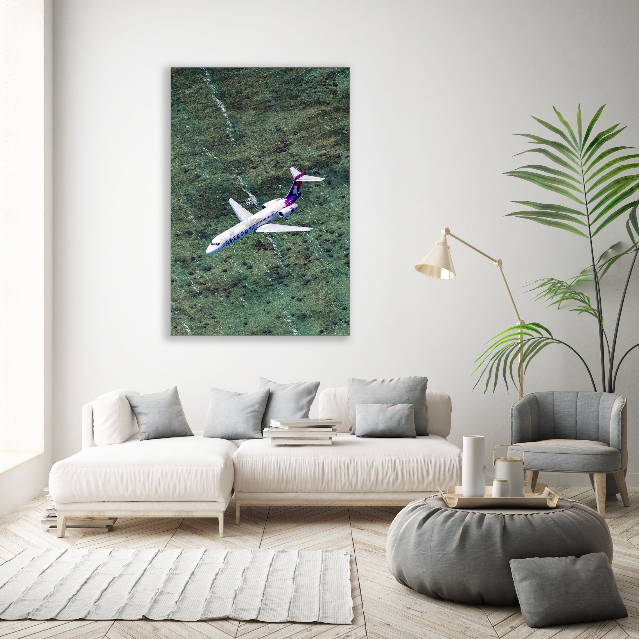 a large airplane flying over a grassy field, with a white sofa and a potted plant in the foreground.